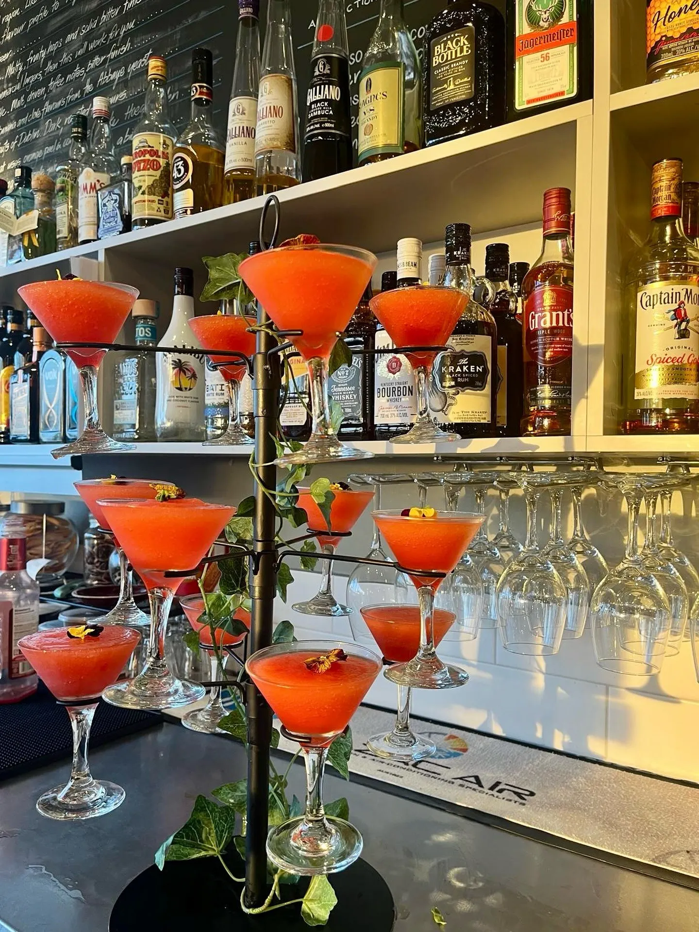 Orange cocktails served on a cocktail tree at Parade Hotel’s bar